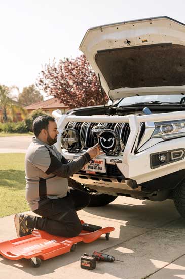 Rajitha from Automart Adelaide working on a vehicle accessories installation