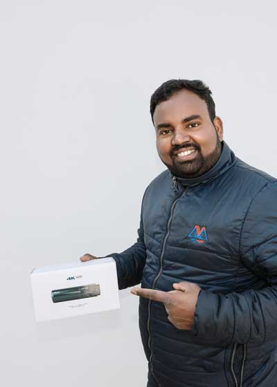 Rajitha, owner of Automart Adelaide, demonstrating a car reverse camera installation.