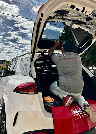 Rajitha from Automart Adelaide working on a vehicle accessories installation